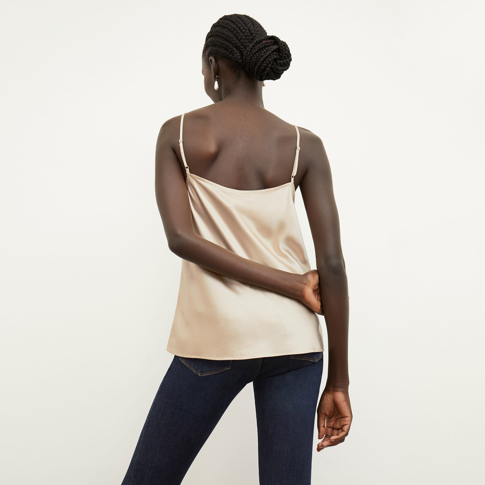 Back image of a woman standing wearing the lisey top in champagne