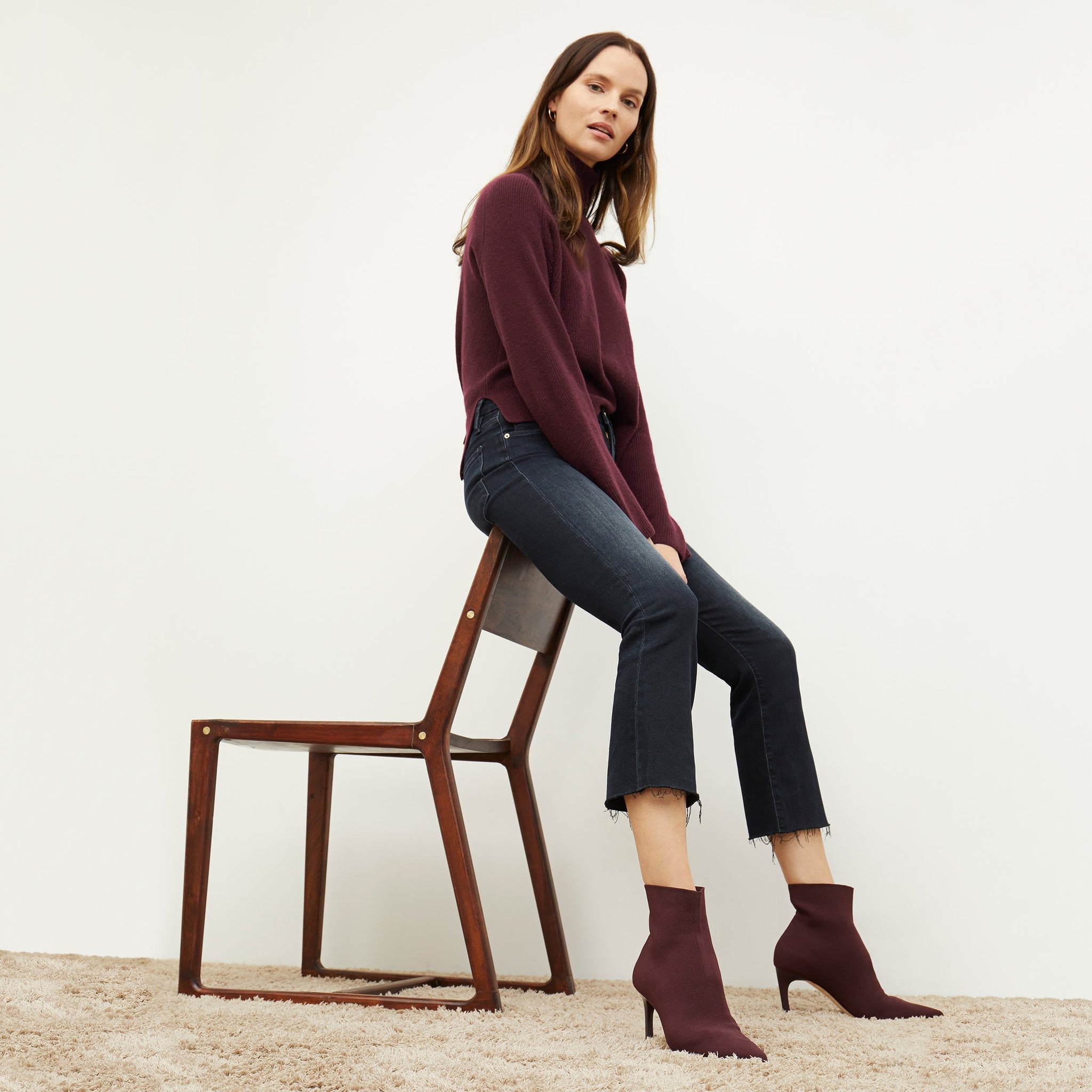 Side image of a woman standing wearing the arbus in chiante