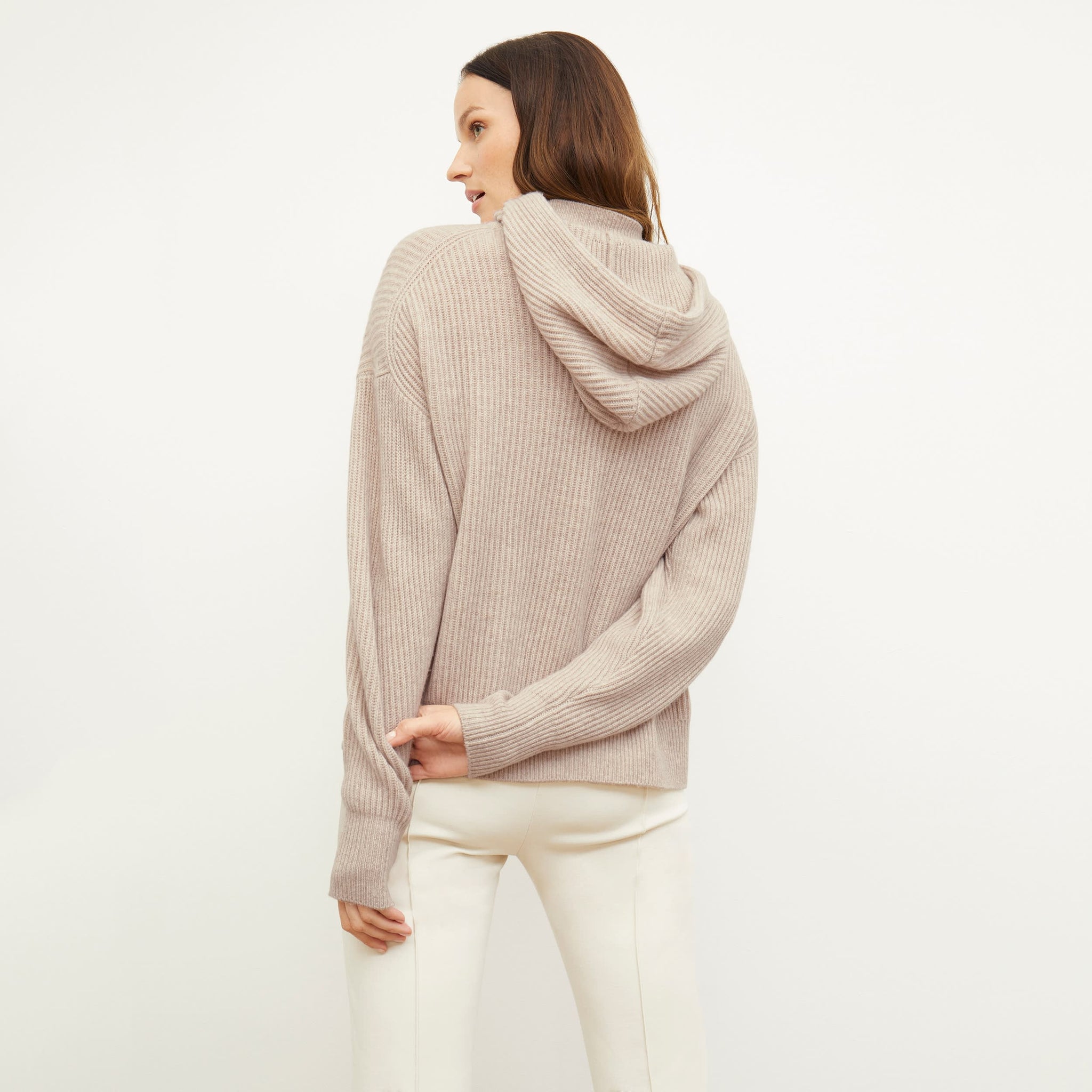 Back image of a woman standing wearing the Freya Hoodie—Cashmere/Wool in Oatmeal Melange