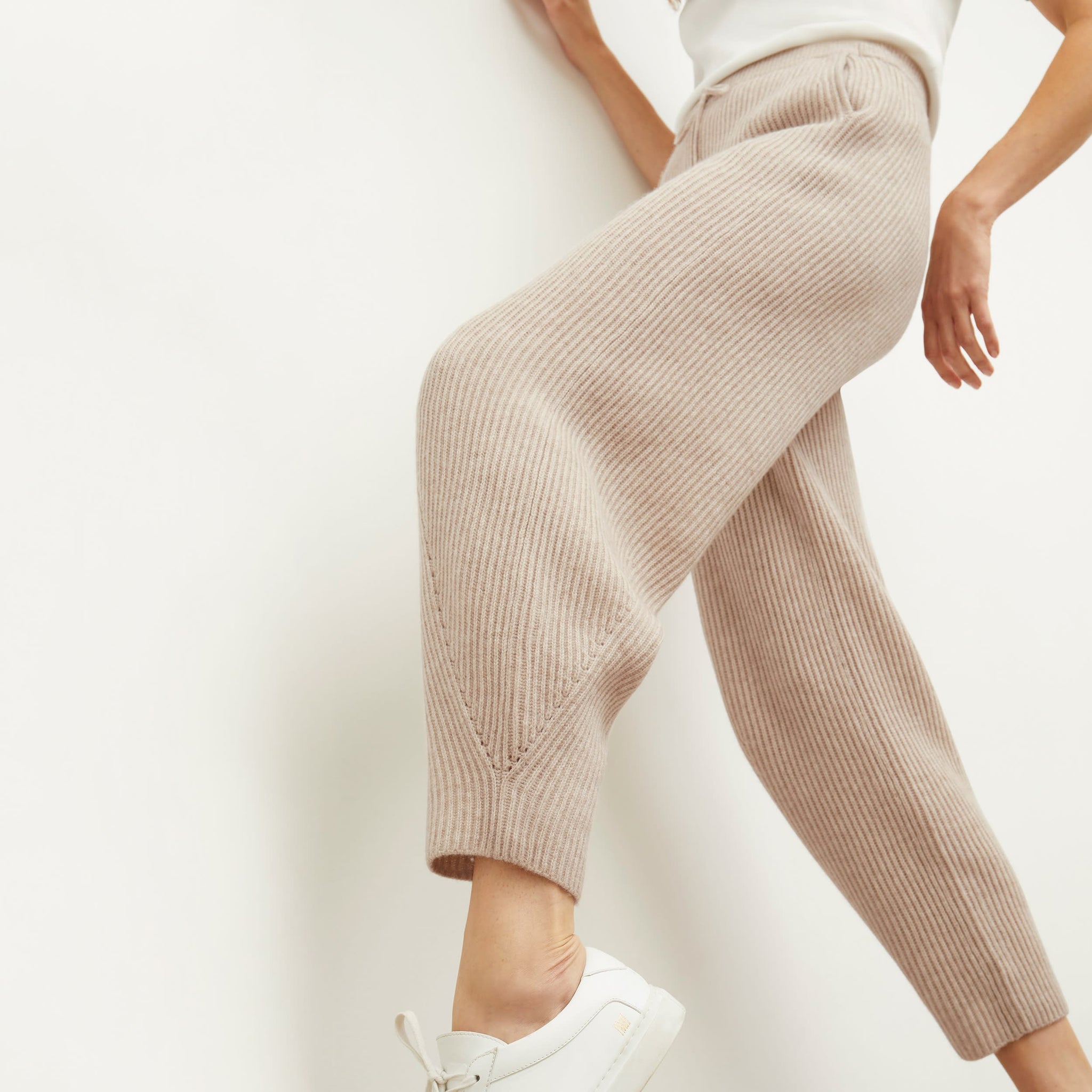 Side image of a woman standing wearing the Addison Jogger—Cashmere/Wool in Oatmeal Melange