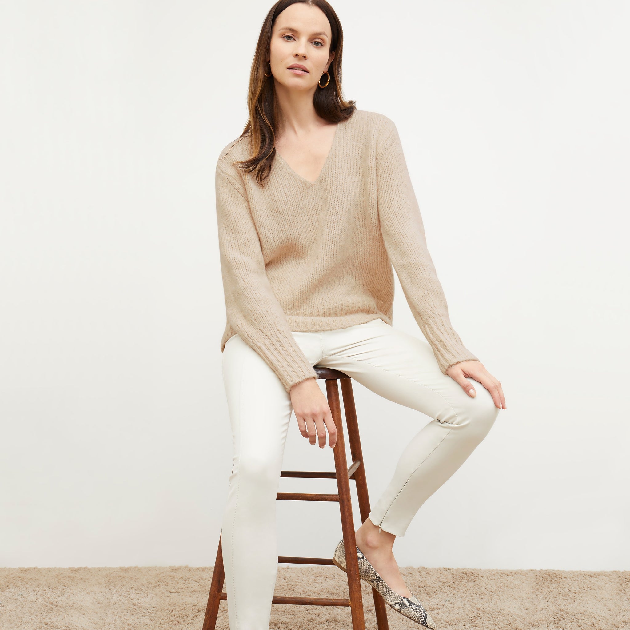 Front image of a woman standing wearing the Cathy Sweater—Glimmer Alpaca in Jasmine