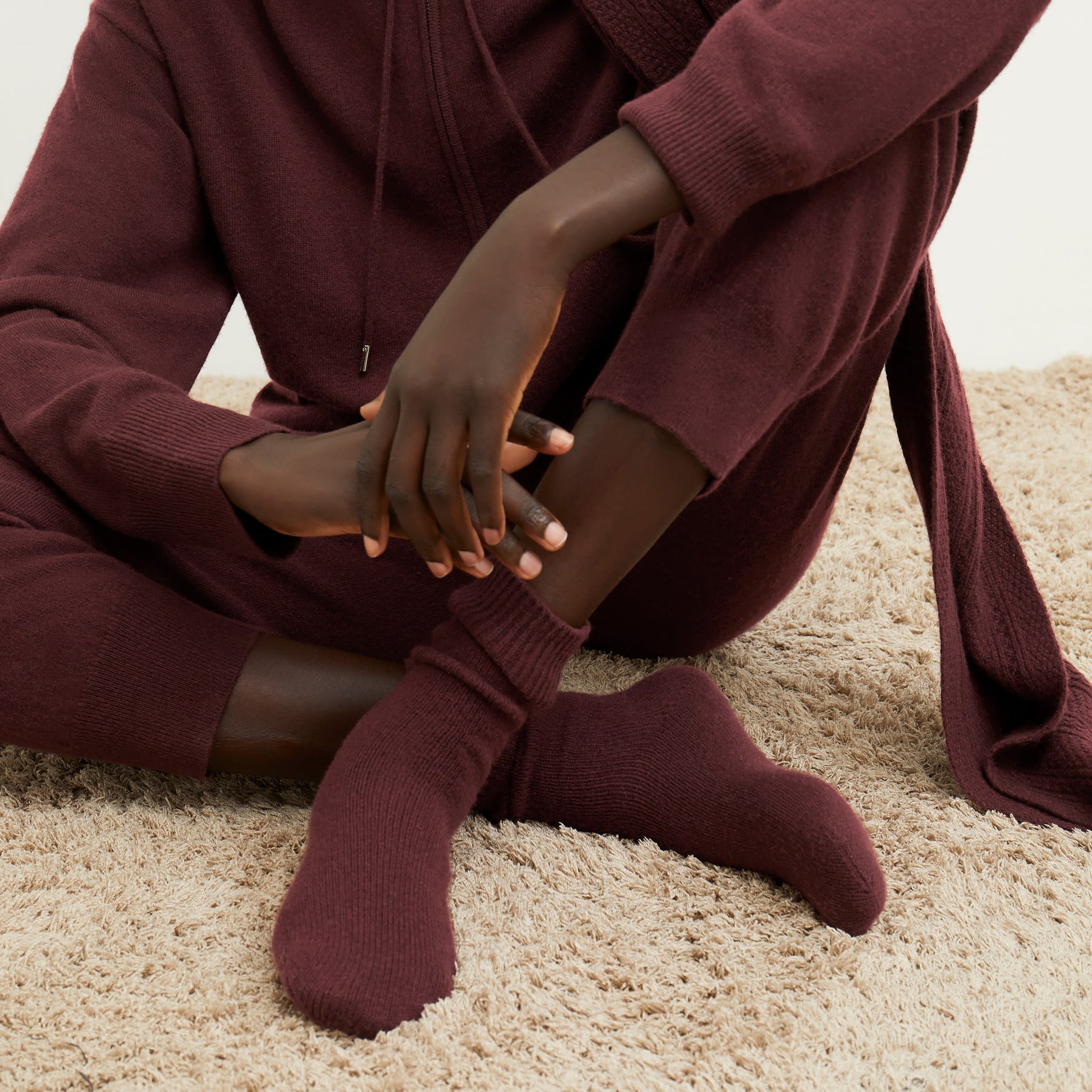 Front image of a woman wearing the ribbed cashmere socks in chiante