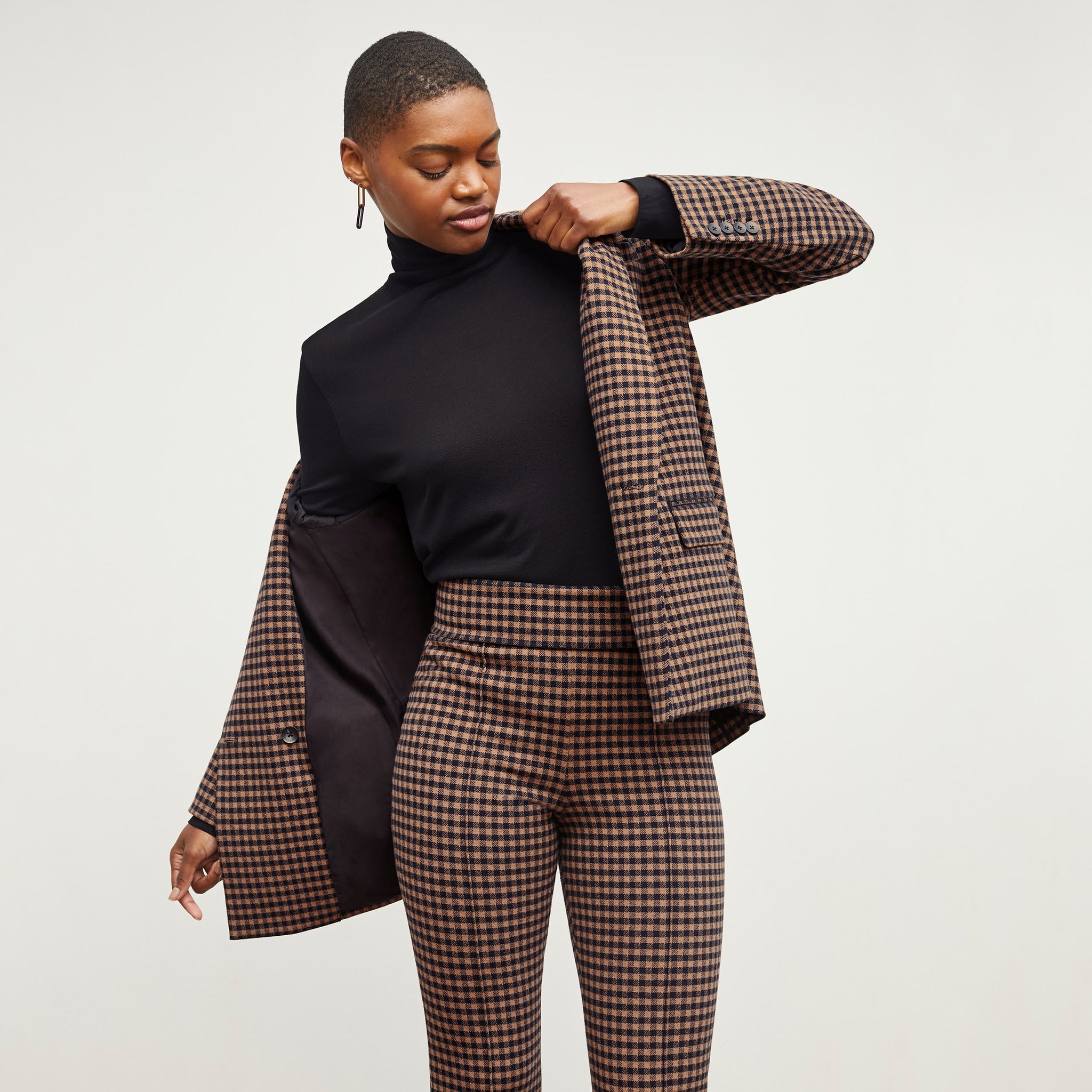 Front image of a woman standing wearing the O'Hara Blazer—Plaid Knit in Camel / Black 
