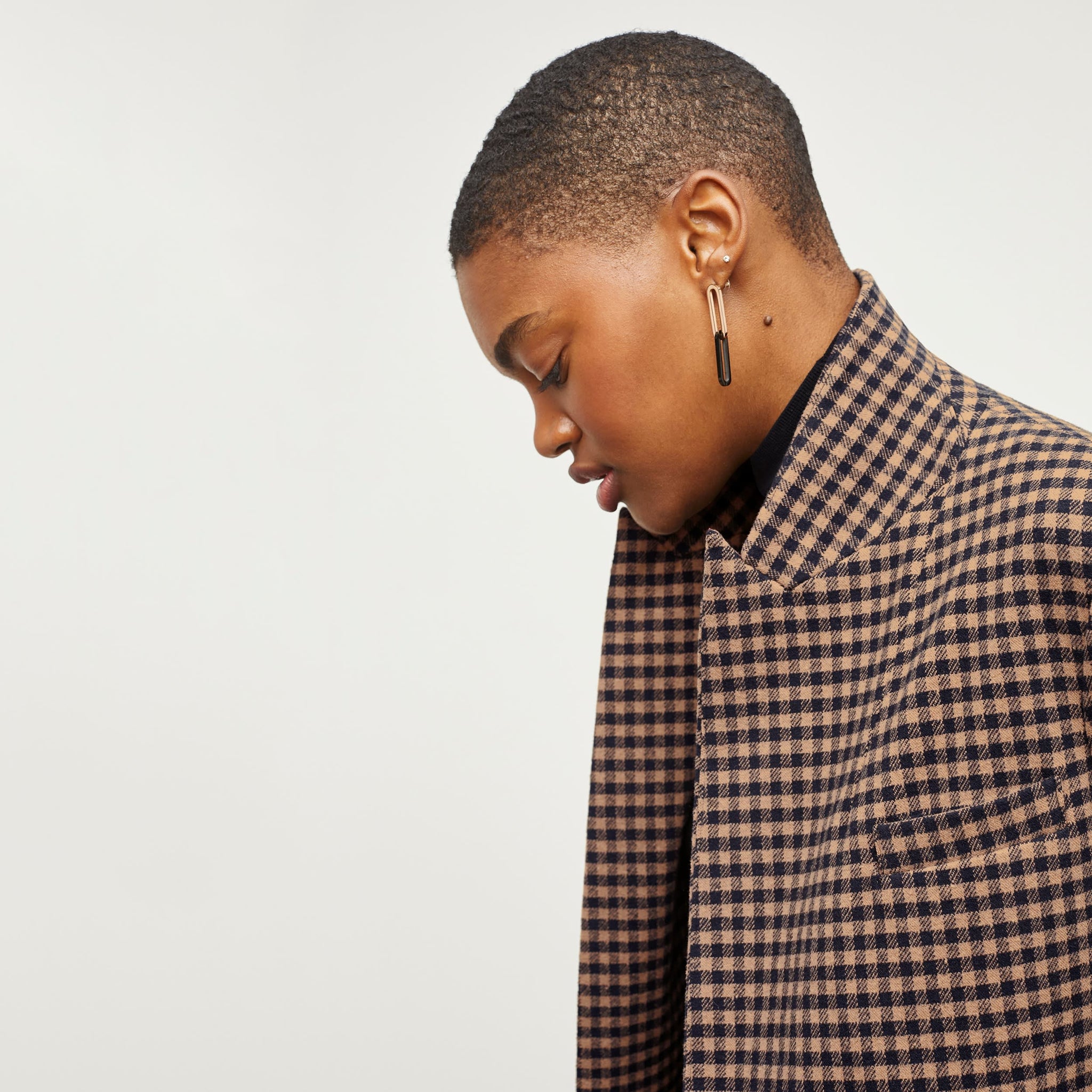 Detail image of a woman standing wearing the O'Hara Blazer—Plaid Knit in Camel / Black