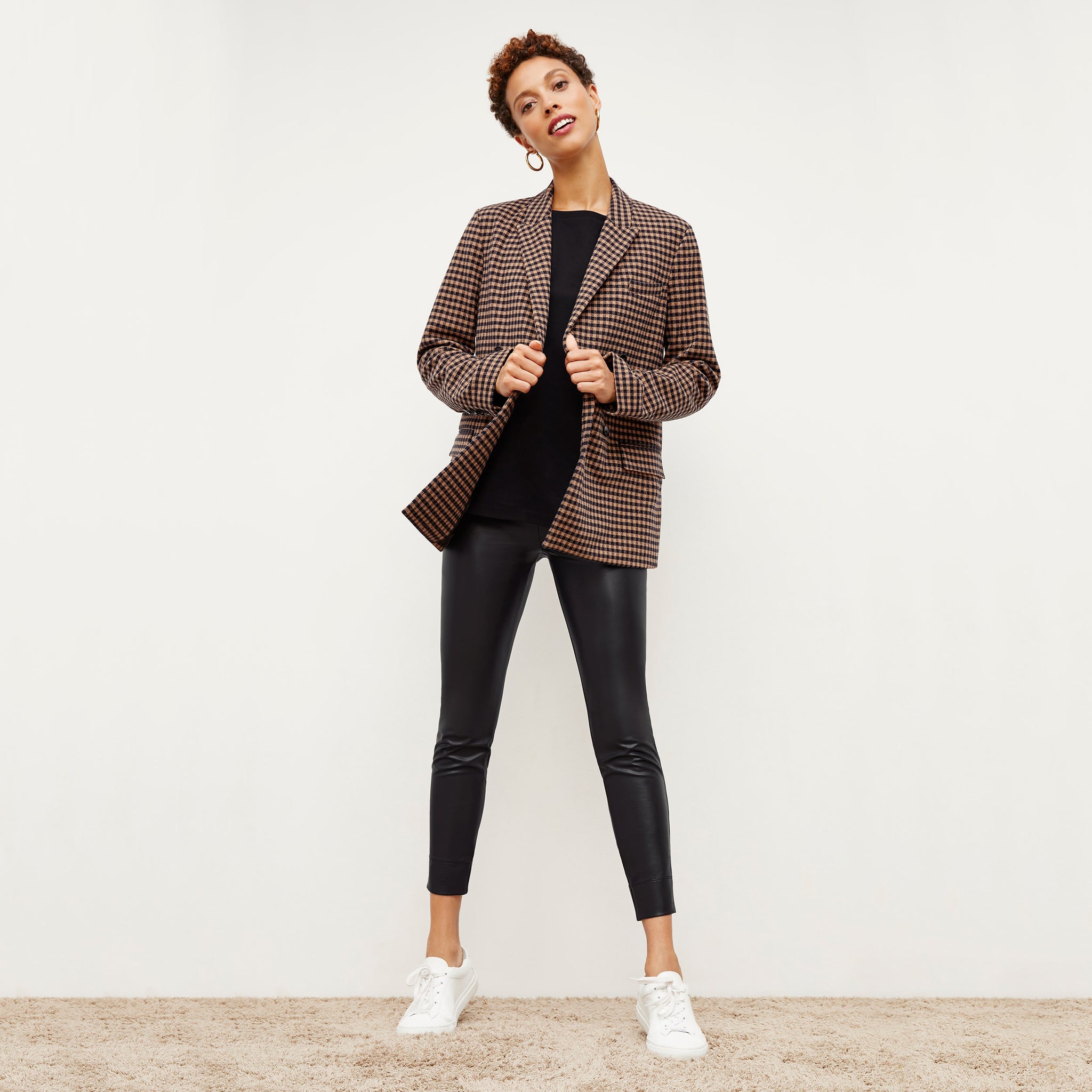 Front image of a woman standing wearing the O'Hara Blazer—Plaid Knit in Camel / Black
