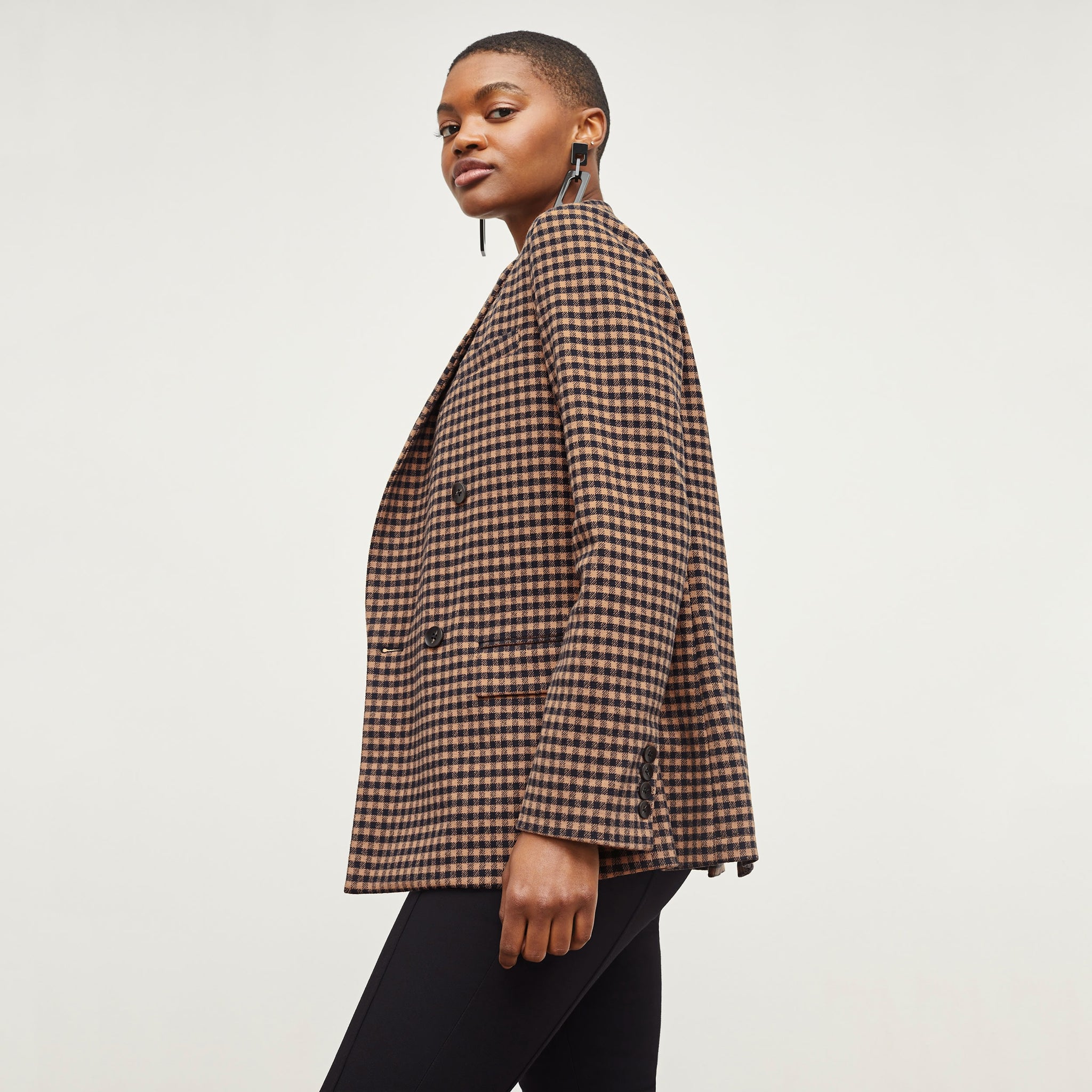 Side image of a woman standing wearing the O'Hara Blazer—Plaid Knit in Camel / Black