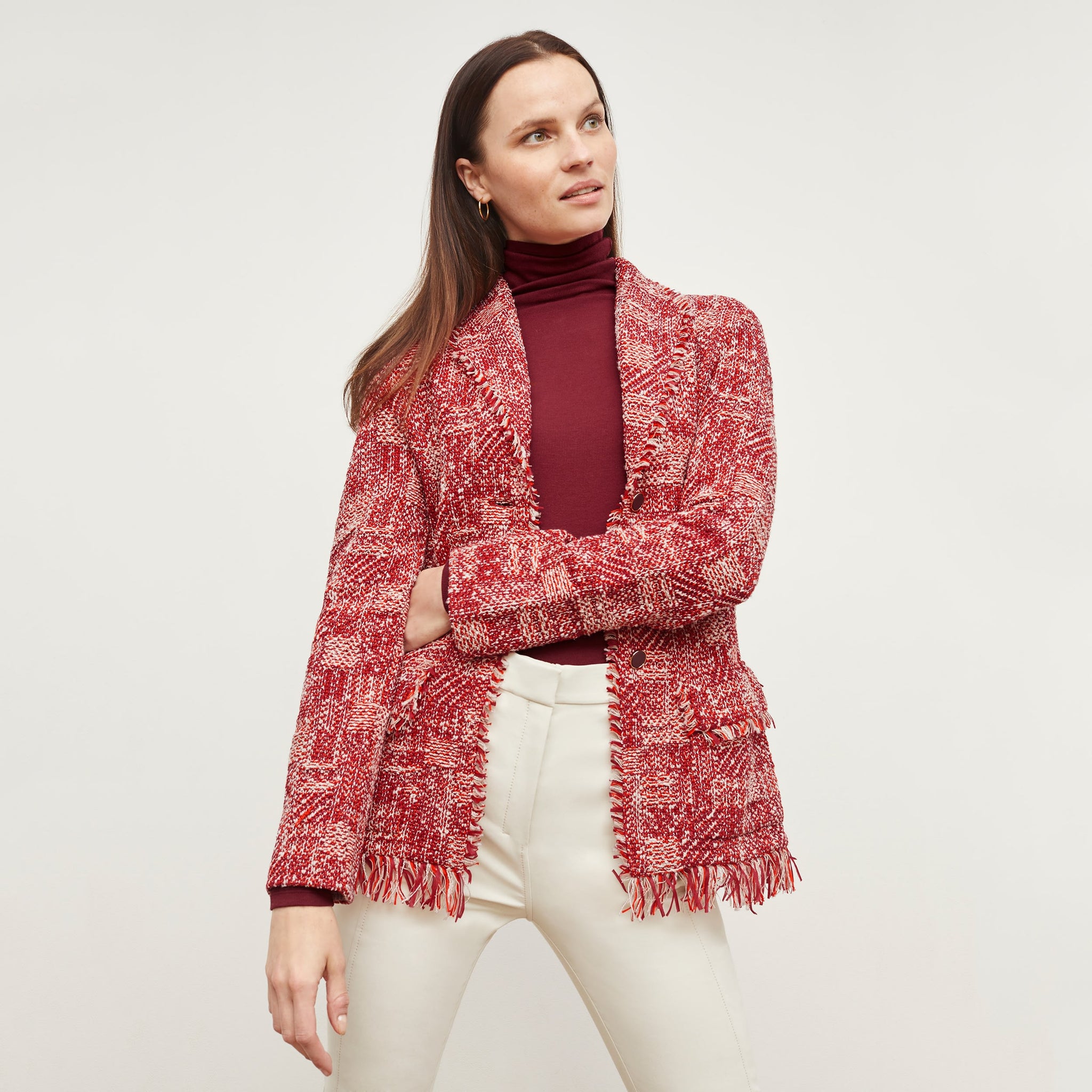 Front image of a woman standing wearing the Porter Jacket—Interweave in Red Multi