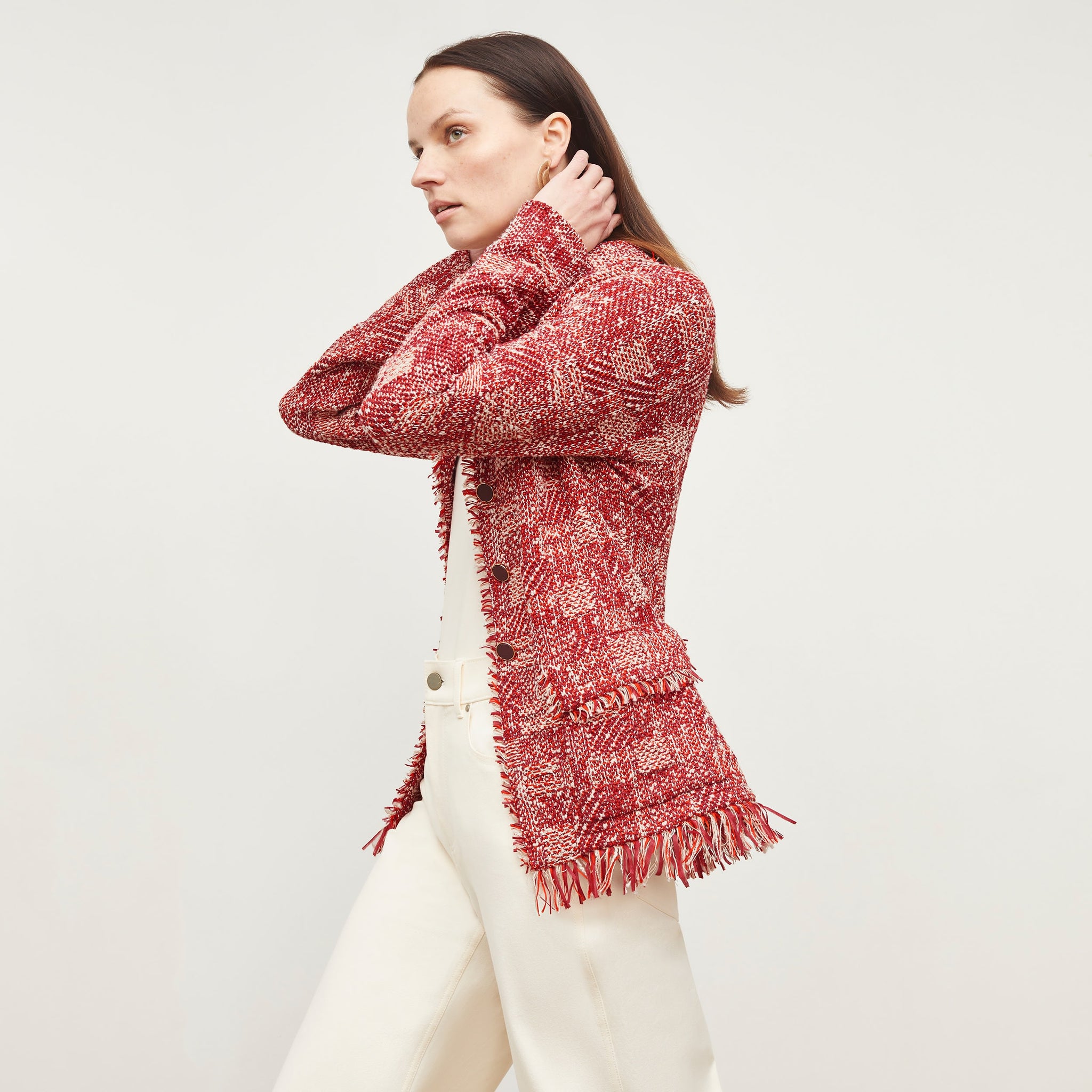 Side image of a woman standing wearing the Porter Jacket—Interweave in Red Multi