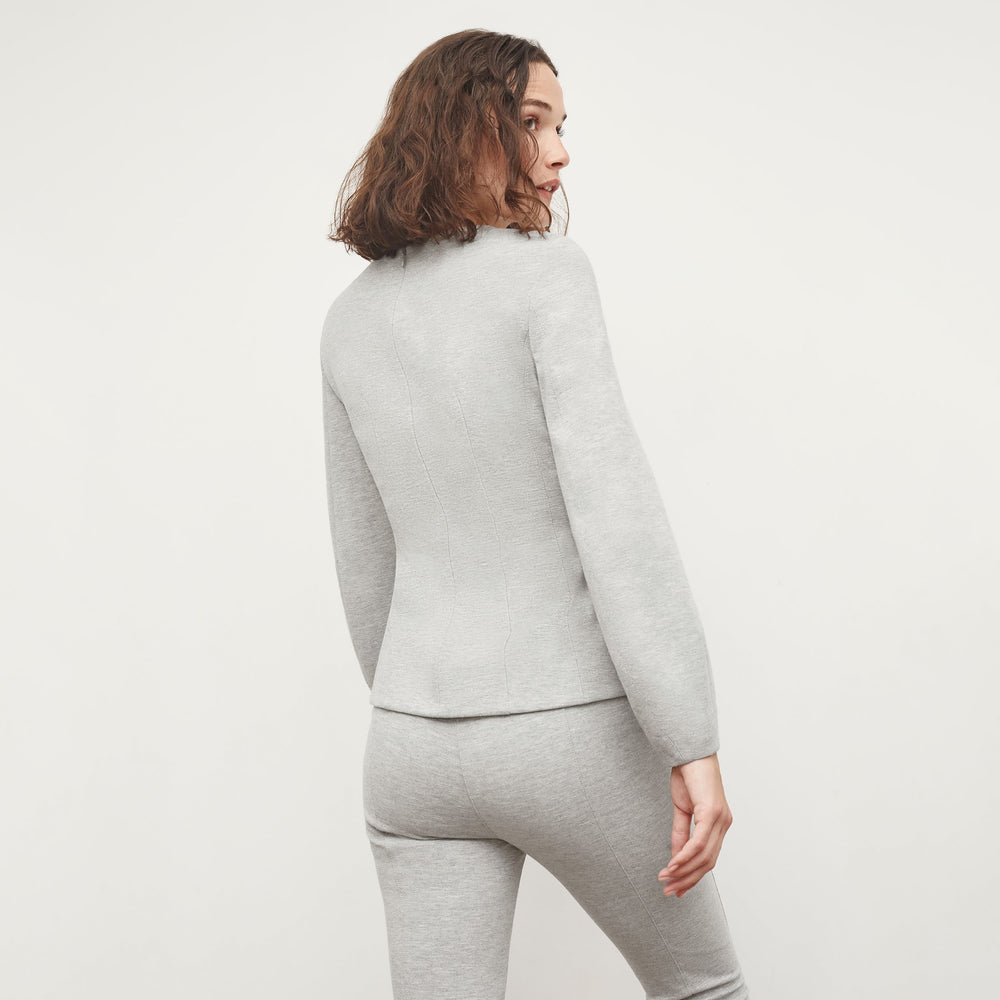 Back image of a woman standing wearing the Rashida Top in Gray Melange