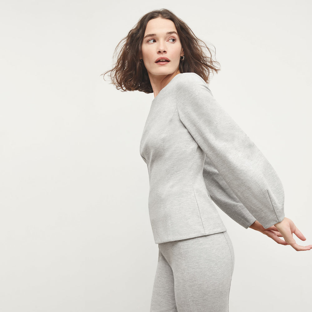 Side image of a woman standing wearing the Rashida Top in Gray Melange