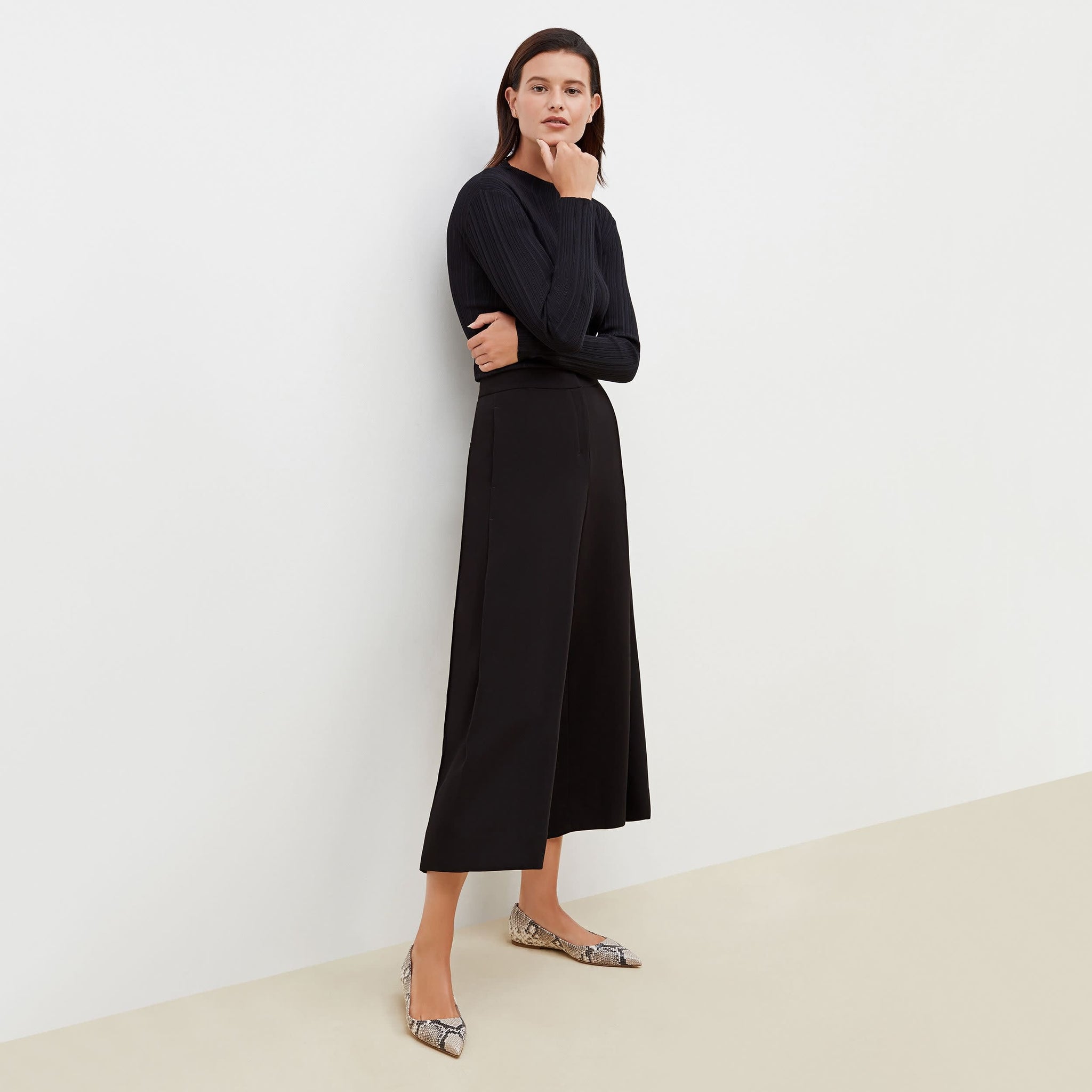 Front image of a woman standing wearing the Zhou culotte in black